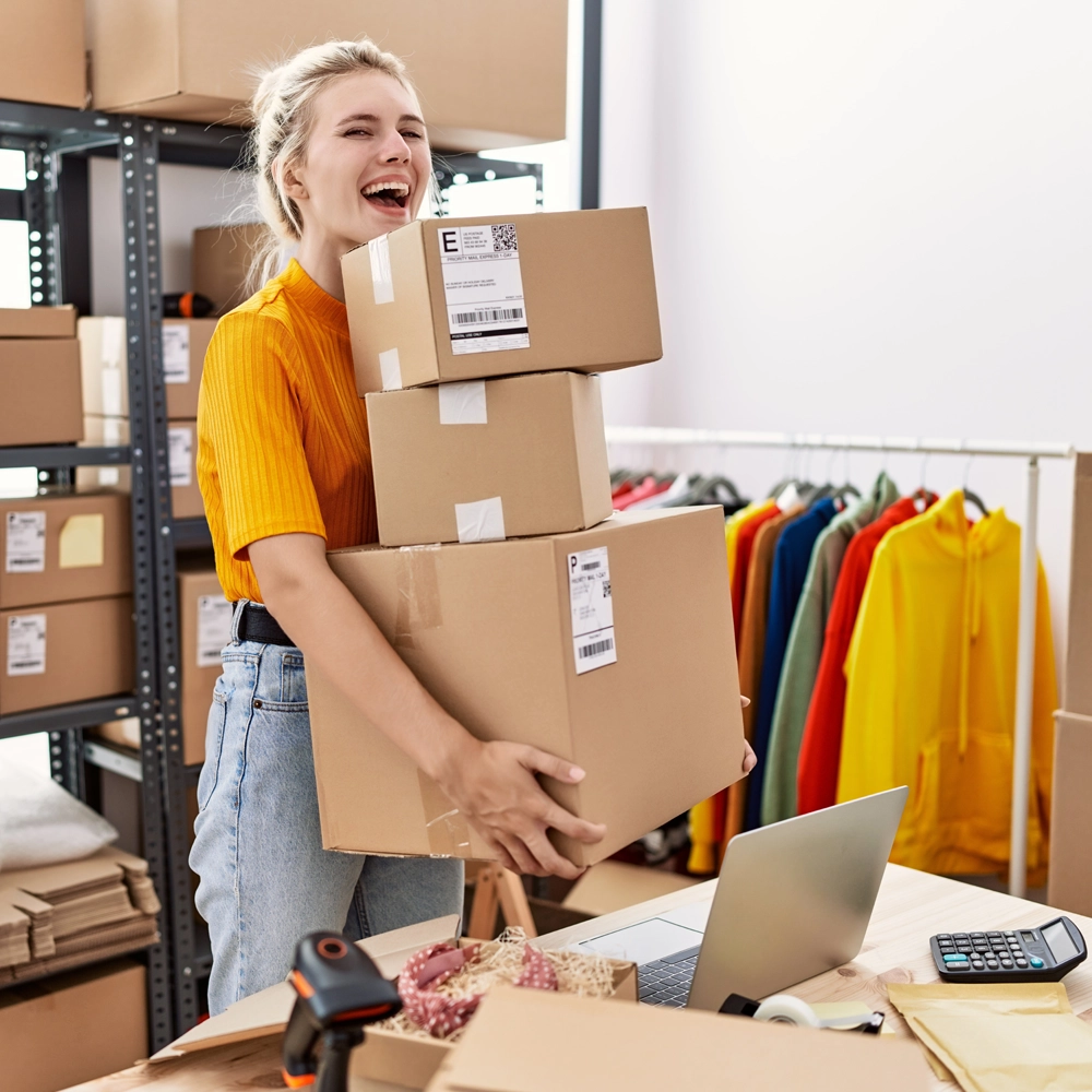 Free basic hosting included with every domain name. Photo of a lady in an orange top carrying parcels in her small business.